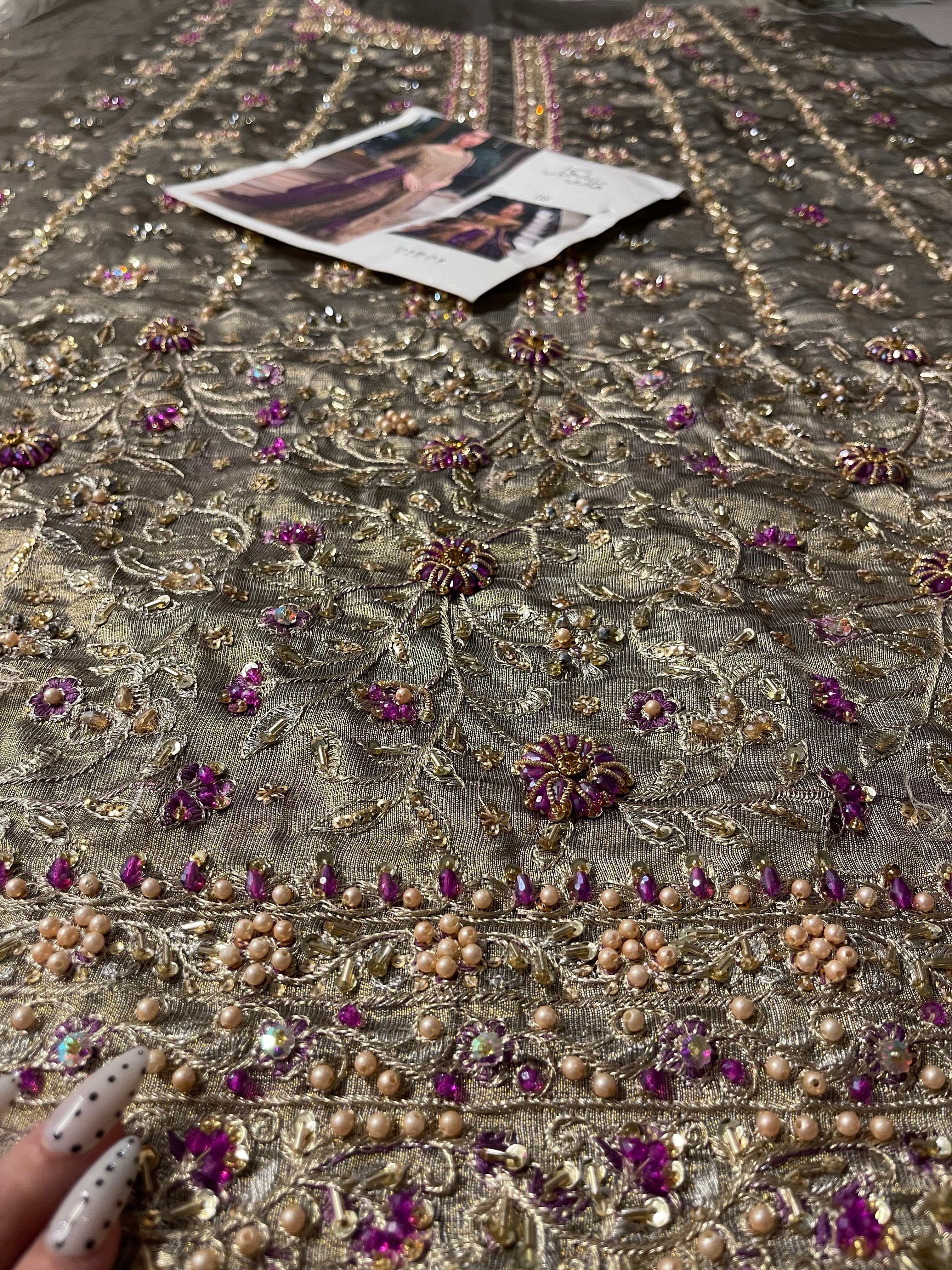 Bronze gold formal dress featuring hand embellishments, intricate embroidery, and statement occasion wear styling.
