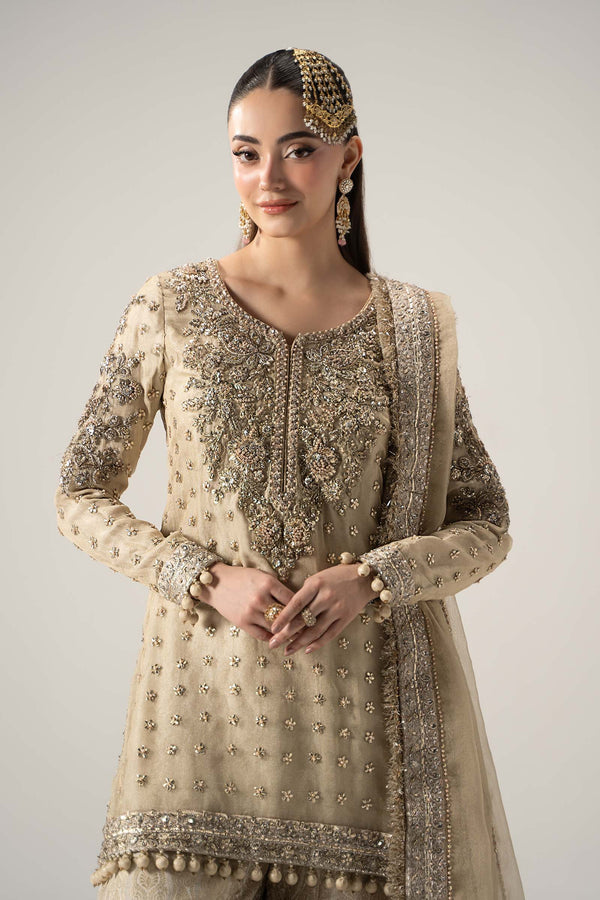 Gold Pakistani Nikah gharara with intricate embroidery and heavy adda work